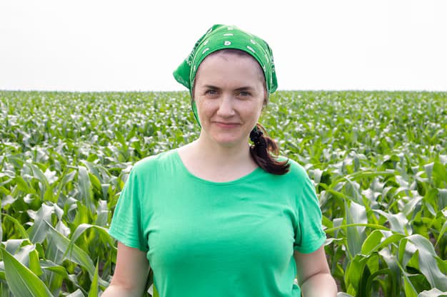 A group of diverse farmers smiling in a sunny field